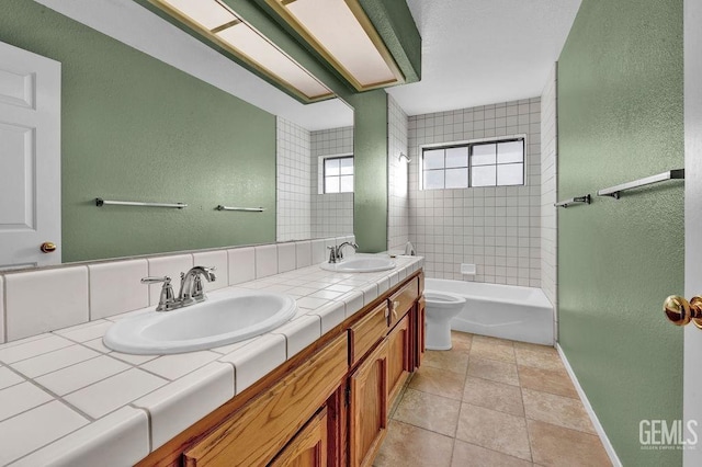 full bath featuring double vanity, toilet, baseboards, and a sink
