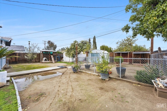 view of yard with an outbuilding and a fenced backyard