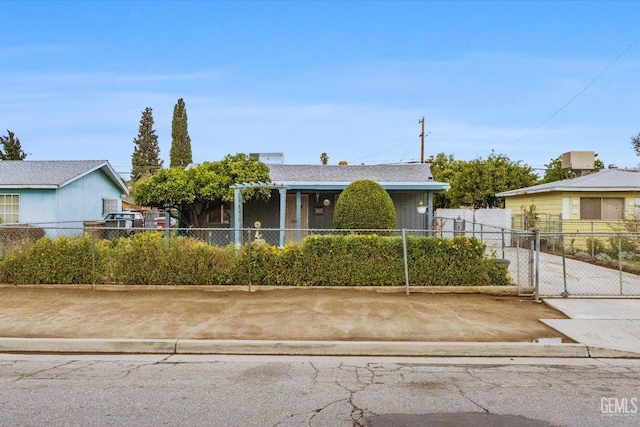 view of front of home featuring a gate, concrete driveway, and fence