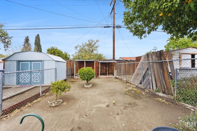 view of patio / terrace featuring an outbuilding, a shed, and a fenced backyard