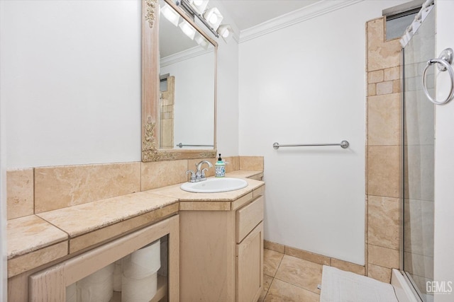 bathroom with vanity, tile patterned floors, tiled shower, and ornamental molding