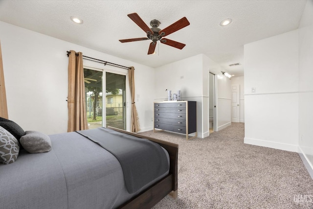 bedroom with carpet, baseboards, visible vents, access to exterior, and a textured ceiling