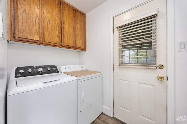 washroom with cabinet space and washer and clothes dryer