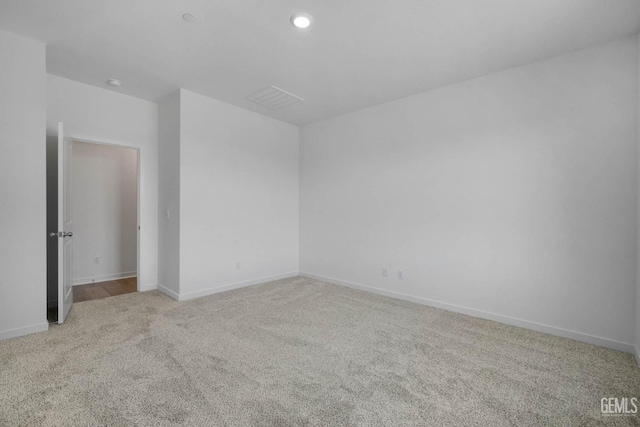 empty room featuring light carpet