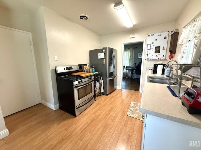 615 Cherokee Dr, Bakersfield, CA 93309 - kitchen featuring stainless steel appliances, light wood-style floors, and light countertops