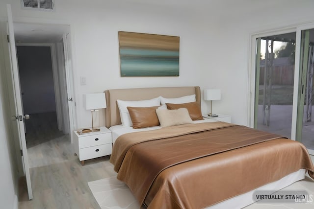 bedroom featuring light hardwood / wood-style floors and access to exterior