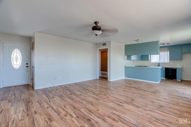 728 D St, Taft, CA 93268 - unfurnished living room featuring light wood finished floors, plenty of natural light, and a ceiling fan