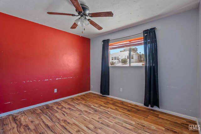 728 D St, Taft, CA 93268 - unfurnished room with wood finished floors, a ceiling fan, and baseboards