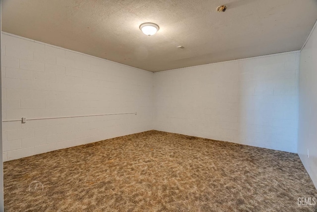 728 D St, Taft, CA 93268 - carpeted spare room featuring concrete block wall and a textured ceiling