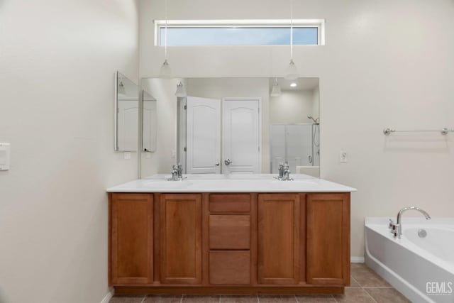 bathroom featuring a shower with door, baseboards, tile patterned flooring, a garden tub, and double vanity
