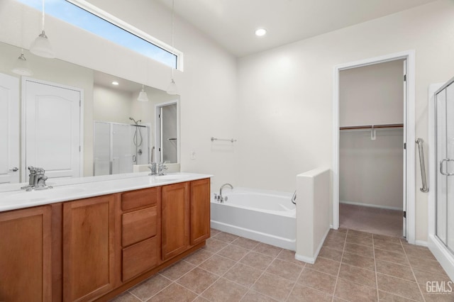 bathroom with a bath, a shower stall, and a sink