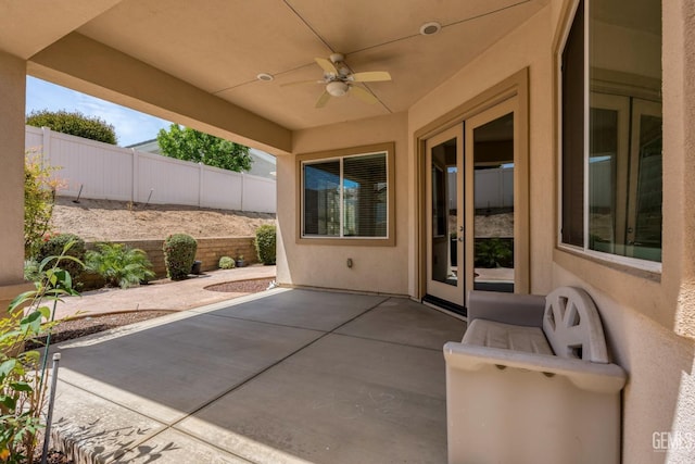 view of patio / terrace with french doors, fence, and a ceiling fan