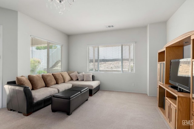 living room with light carpet, baseboards, and visible vents