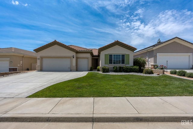 view of front facade with a tiled roof, an attached garage, stucco siding, concrete driveway, and a front yard