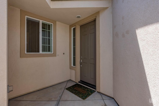entrance to property with stucco siding