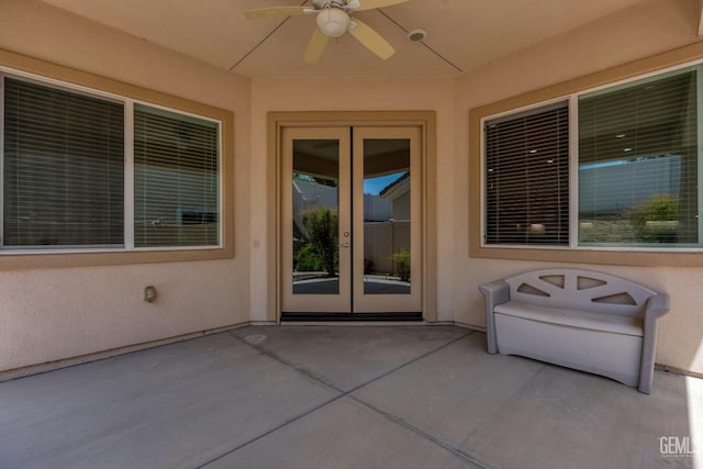doorway to property with a patio area, stucco siding, french doors, and a ceiling fan