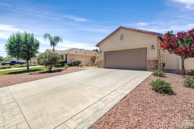 14030 Sandstone Peak Dr, Bakersfield, CA 93306 - view of front of house featuring concrete driveway, stucco siding, stone siding, and an attached garage