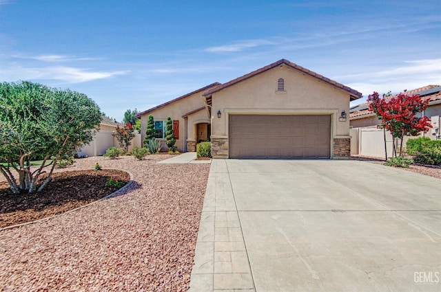 14030 Sandstone Peak Dr, Bakersfield, CA 93306 - view of front of property featuring stone siding, stucco siding, driveway, and a garage