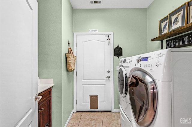 14030 Sandstone Peak Dr, Bakersfield, CA 93306 - laundry area featuring cabinet space, washer and clothes dryer, and light tile patterned flooring