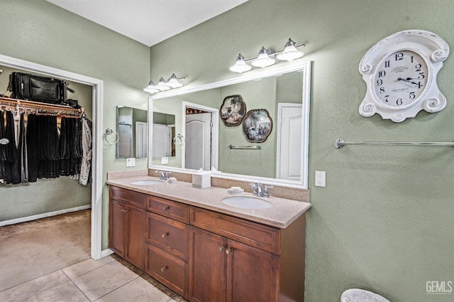 14030 Sandstone Peak Dr, Bakersfield, CA 93306 - full bathroom featuring double vanity, tile patterned floors, and a walk in closet
