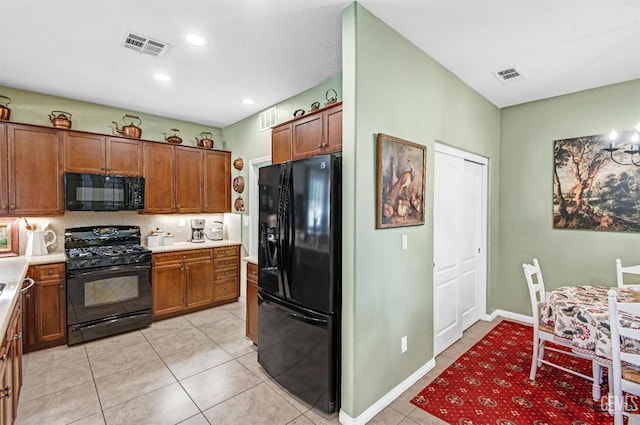 14030 Sandstone Peak Dr, Bakersfield, CA 93306 - kitchen featuring black appliances, brown cabinets, light countertops, light tile patterned floors, and recessed lighting