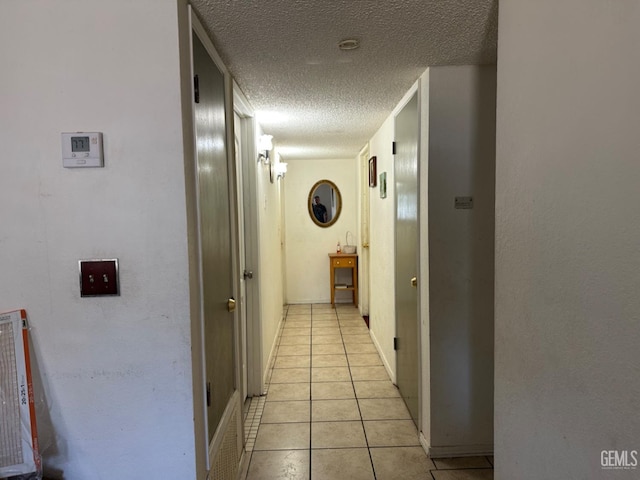 819 Stephen Ct, Wasco, CA 93280 - hallway with a textured ceiling and light tile patterned floors