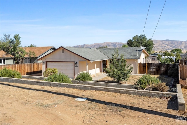 ranch-style house with a garage and a mountain view