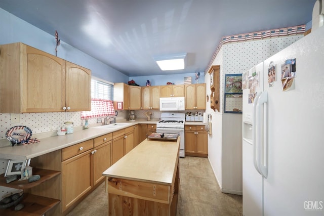 kitchen featuring backsplash, sink, white appliances, and light brown cabinets