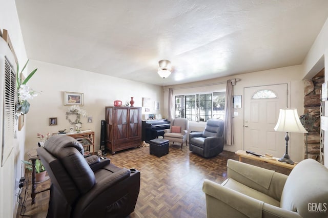 living room with parquet floors and a textured ceiling