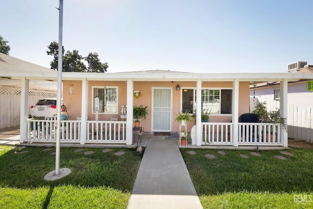 view of front of home with a porch and a front yard