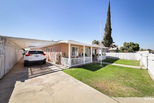 view of front of property with a front lawn, covered porch, and a carport