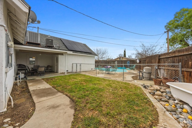 view of yard with outdoor dining space, a fenced backyard, and a patio