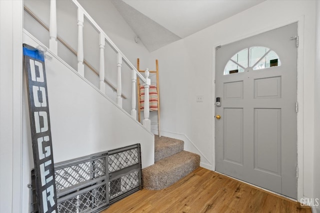 foyer entrance with stairs and wood finished floors