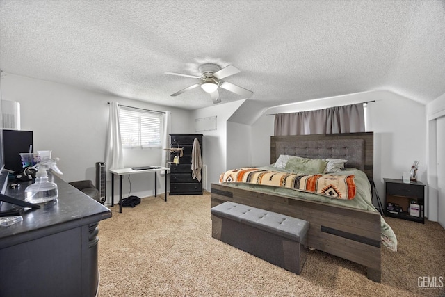 bedroom featuring a ceiling fan, light carpet, and a textured ceiling