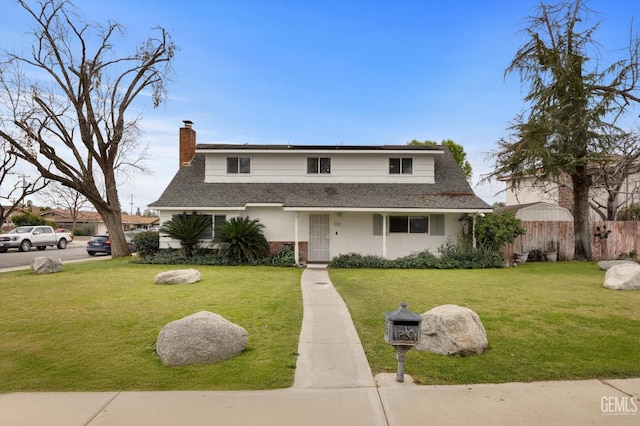 view of front of home with a front lawn, a chimney, a shingled roof, and fence