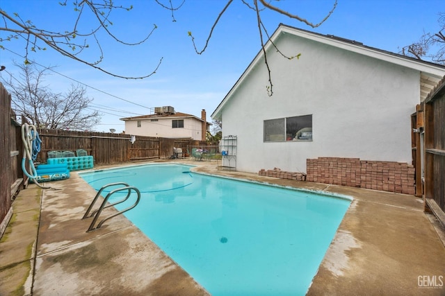 view of pool with a fenced backyard, a fenced in pool, and a patio