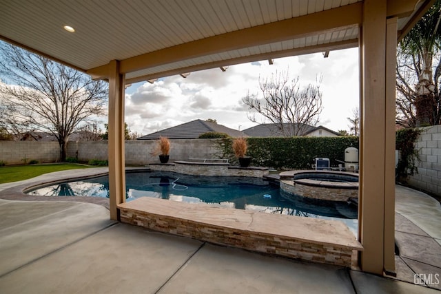 view of pool with an in ground hot tub and a patio