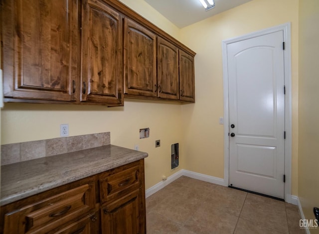 laundry room featuring light tile patterned flooring, cabinets, washer hookup, and electric dryer hookup