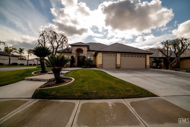 view of front of property featuring a garage and a front yard