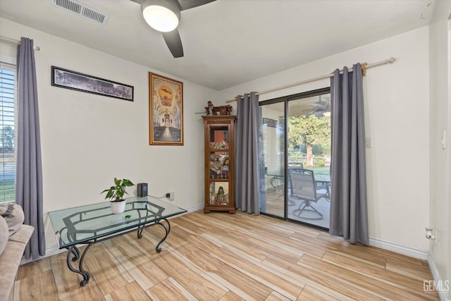 living area featuring ceiling fan and light hardwood / wood-style flooring