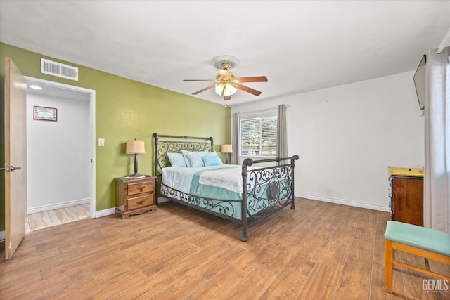 bedroom with ceiling fan and light hardwood / wood-style floors