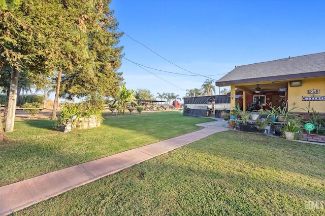 view of yard featuring ceiling fan