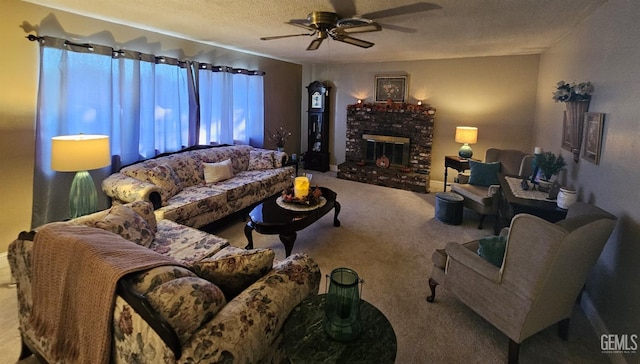 living room featuring ceiling fan, a fireplace, carpet, and a textured ceiling