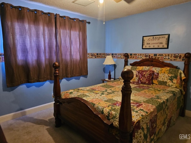 bedroom with carpet flooring, ceiling fan, and a textured ceiling