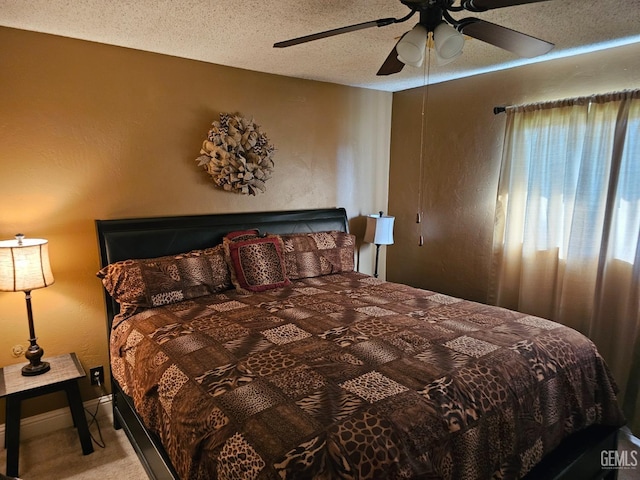 carpeted bedroom featuring a textured ceiling and ceiling fan