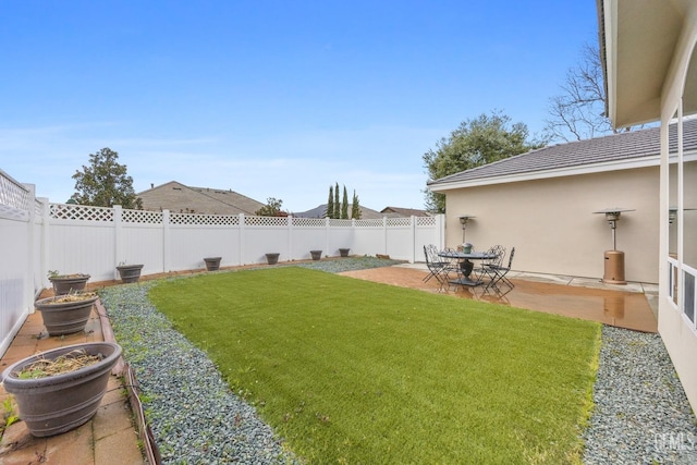 view of yard with a fenced backyard and a patio