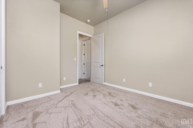 unfurnished bedroom with baseboards, lofted ceiling, ceiling fan, and carpet flooring