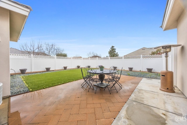 view of patio featuring outdoor dining area and a fenced backyard