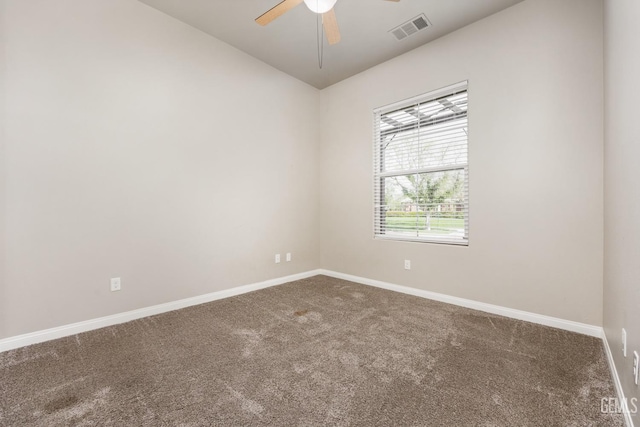 spare room featuring visible vents, carpet flooring, baseboards, and ceiling fan