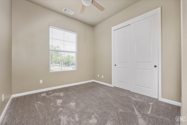 unfurnished bedroom featuring a closet, visible vents, baseboards, and carpet floors